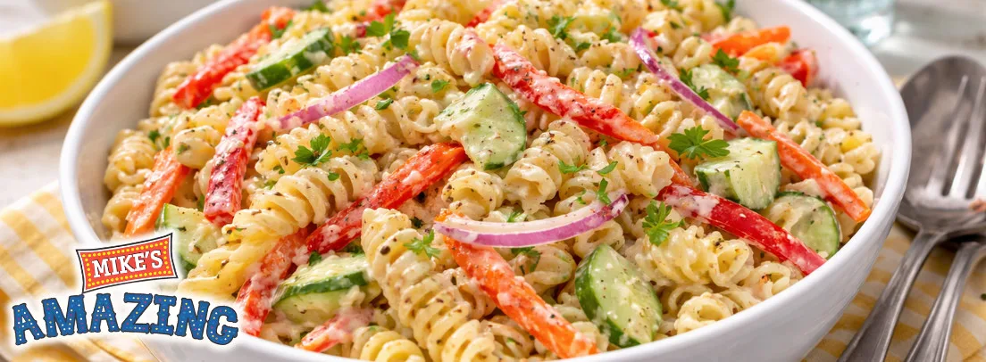 Vibrant pasta salad with rotini, fresh vegetables, and herbs—ideal for wholesale food distribution and foodservice suppliers.