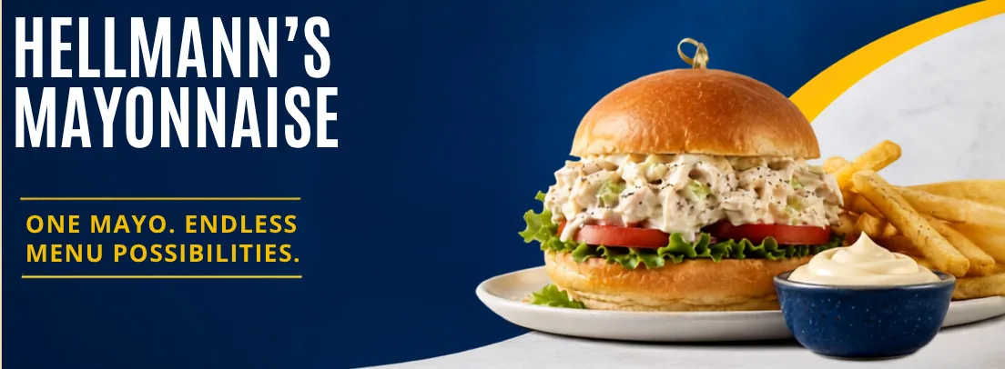Hellmann's mayo chicken salad sandwich with lettuce and tomato on brioche bun, served with fries and mayo dip.