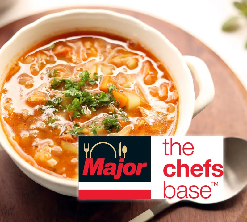 Bowl of hearty tomato vegetable soup with carrots and fresh parsley, featuring Major The Chefs Base foodservice branding.