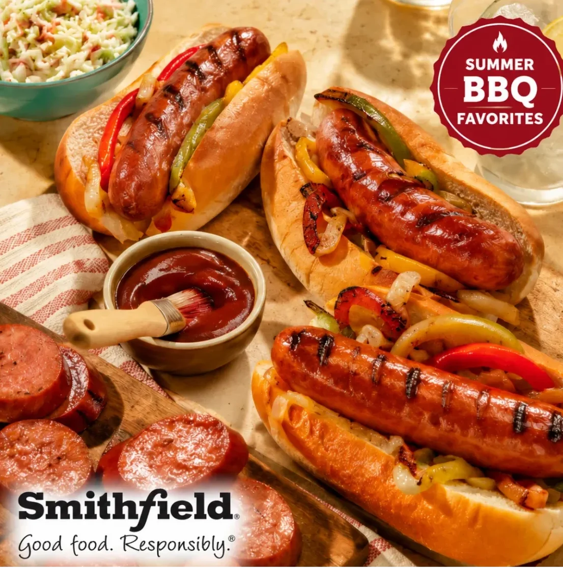 Grilled sausages and hotdogs with peppers and onions on buns, featuring Smithfield premium meat products for foodservice BBQ catering.